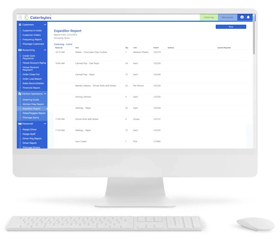 A digital screenshot of a white desktop monitor displays the Caterbytes "Expediter Report" for kitchen operations. The screen shows a detailed log of catering items to be prepared, including Chocolate Chip Cookies, Diet Pepsi, and Dinner Rolls with Butter, organized by "Ready By" times ranging from 10:15 AM to 11:30 AM. A blue navigation sidebar on the left highlights kitchen-specific tools such as Ordering Guide and Kitchen Prep Report, and a white keyboard and mouse sit in the foreground.
